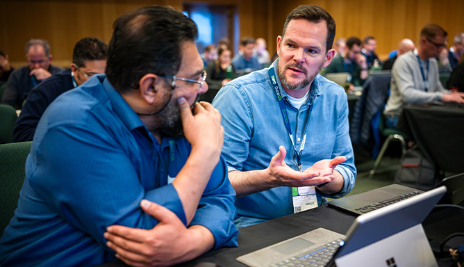 Two delegates chatting during a tutorial at ESPC25
