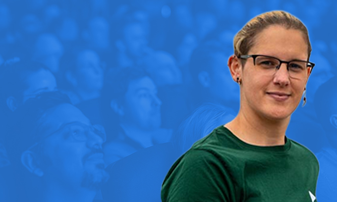 EPPC sponsor Christina Wagner smiles for the camera over a background of a sitting audience