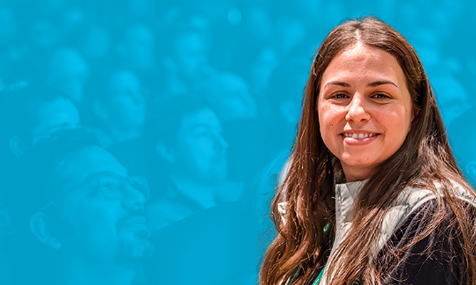 ESPC sponsor Yamada Boukmakh smiles for the camera over a background of a sitting audience